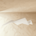 Clérachic's white bar chandelier curves in a sweeping fan shape, lit softly against a warm plaster wall.