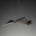 Clérachic's black bar chandelier hangs its sweeping fan shape against a plain grey studio backdrop.