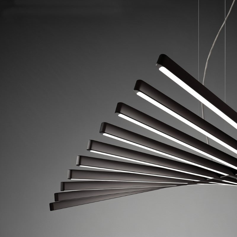 A close view of the Clérachic chandelier shows its dark bars glowing white along their sculptural fan.