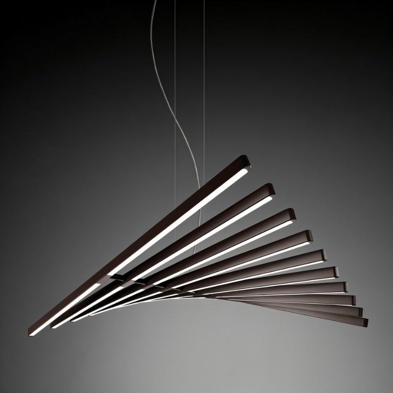 Clérachic's black bar chandelier fans its glowing bars against a dark backdrop in profile view.