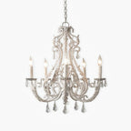 An unlit Clérachic chandelier with beaded scrolling arms and clear crystal drops, on a plain white background.