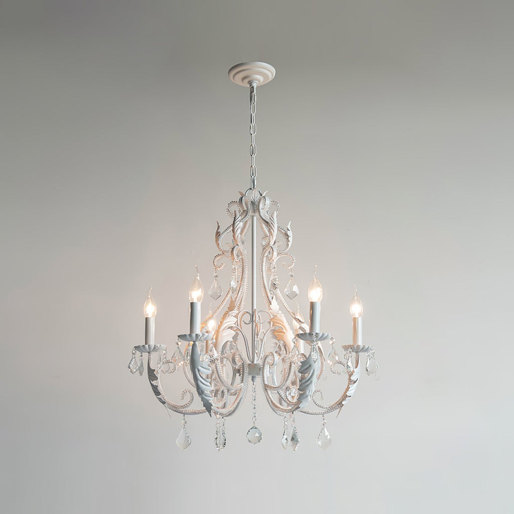 A smaller Clérachic chandelier with white metalwork and a white ceiling cup, lit against a pale grey wall.