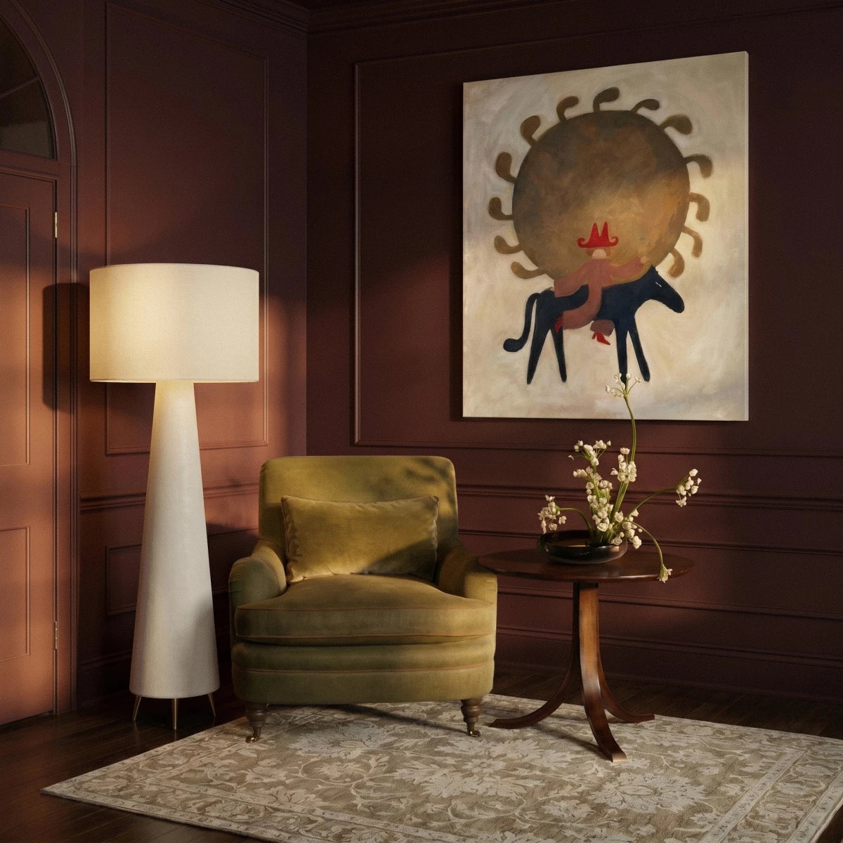 Clérachic tall white drum shade floor lamp beside an olive velvet armchair, in a room with deep plum panelled walls.