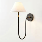 Black Clérachic wall light mirrored to the left, with the white shade at the left and the round backplate at the right.