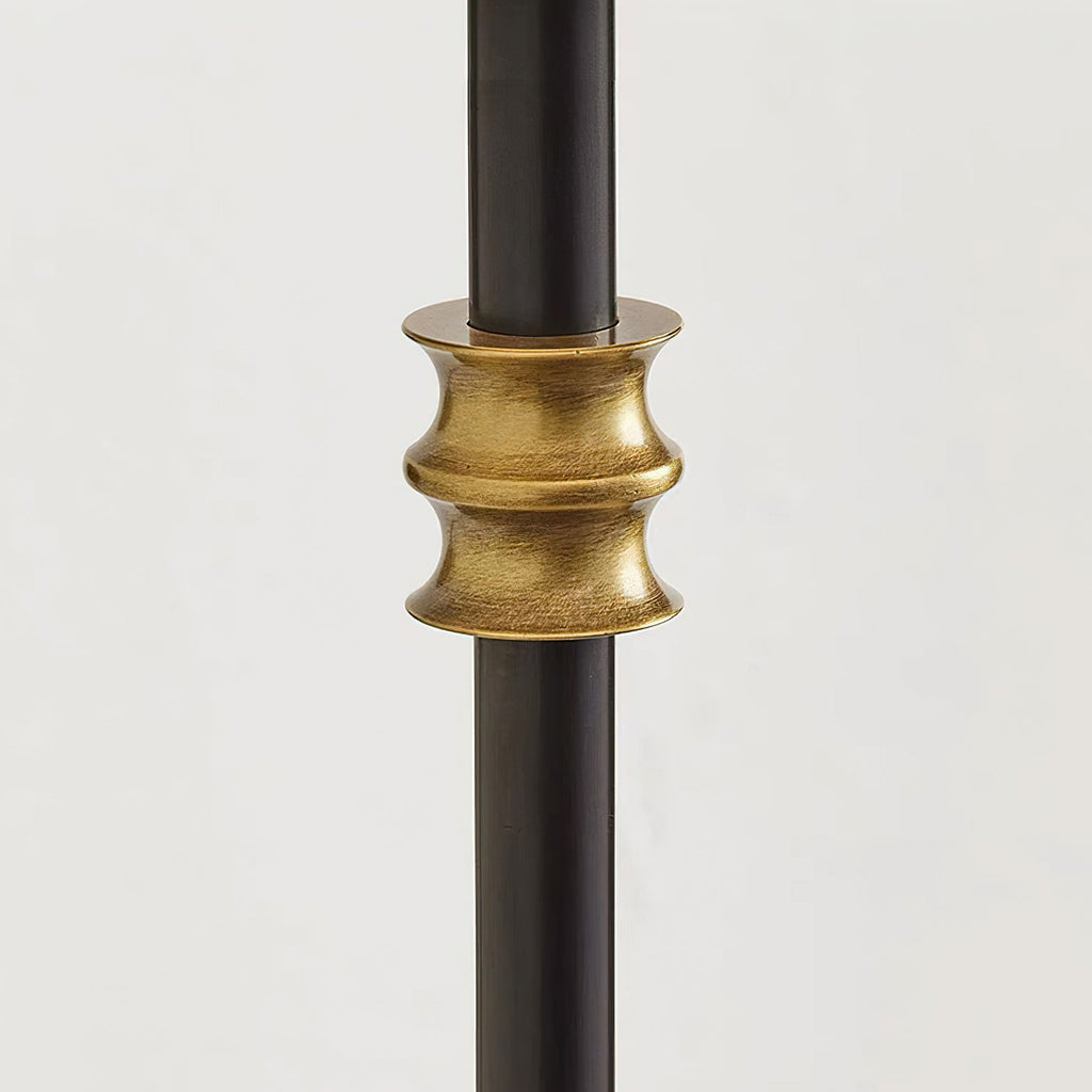 Close view of a brass band around the black stem of this Clérachic wall light, ridged and slightly aged in tone.