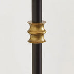 Close view of a brass band around the black stem of this Clérachic wall light, ridged and slightly aged in tone.