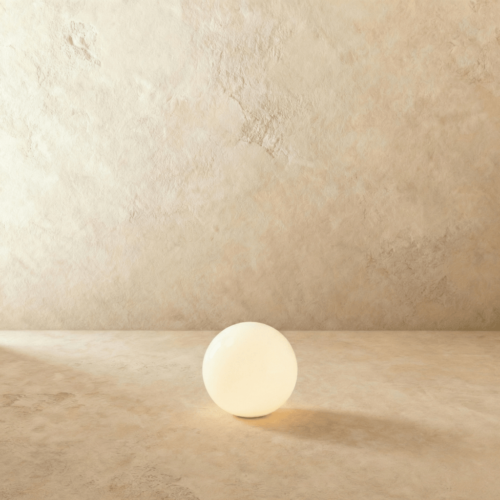 This Clérachic sphere floor lamp appears unlit here, showing its smooth opal glass surface and texture.