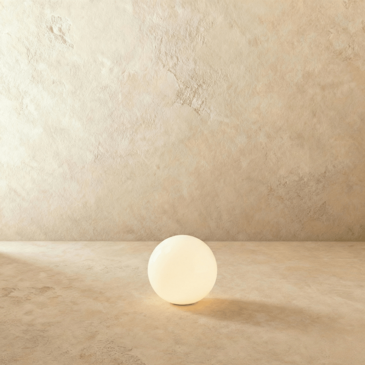 This Clérachic sphere floor lamp appears unlit here, showing its smooth opal glass surface and texture.