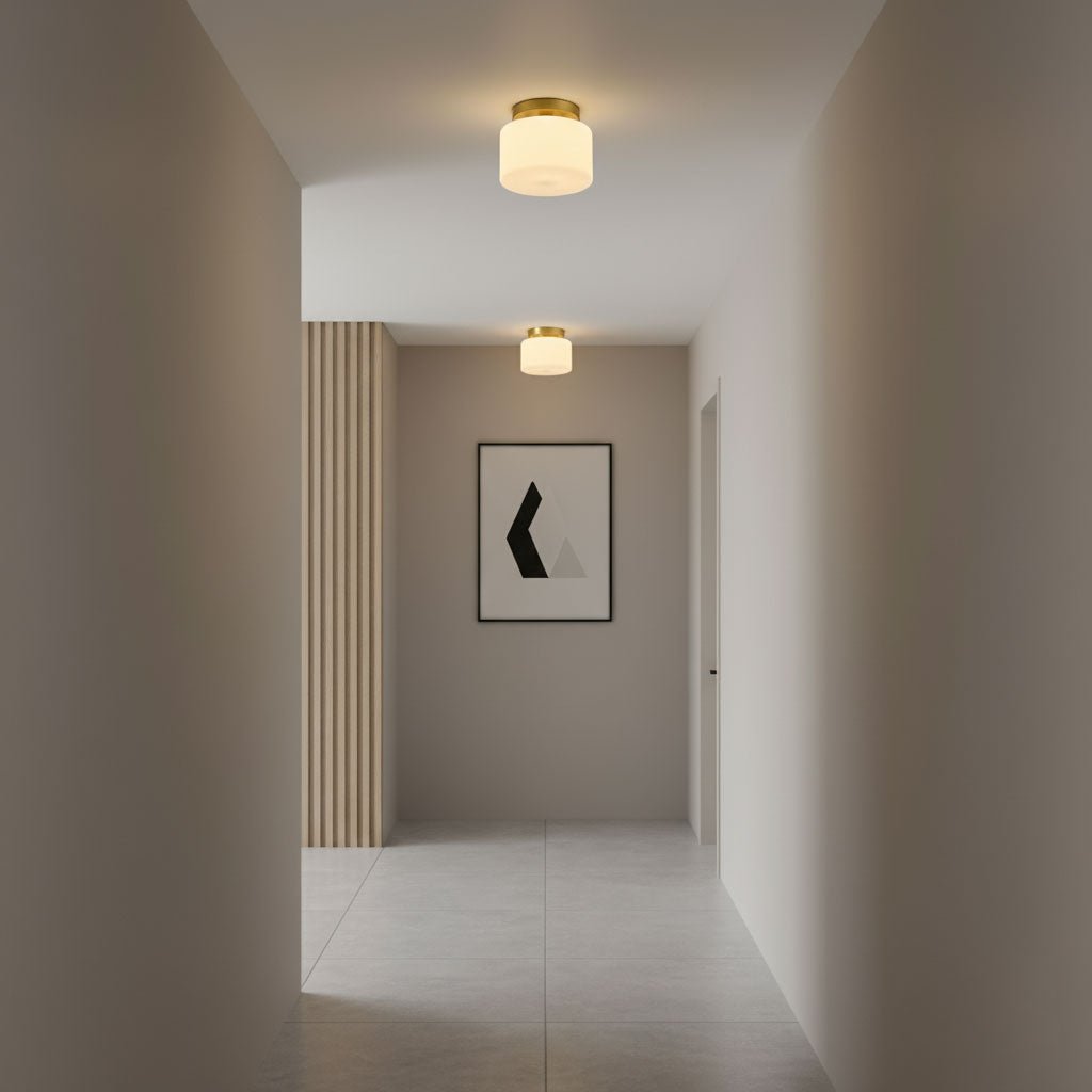 Two small Clérachic flush-mount lights in a narrow grey hallway with a pale tiled floor and a single framed print on the far wall.
