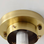 Underside of this Clérachic brass canopy, showing the fixing screws and the white ribbed lamp holder inside before the shade is fitted.