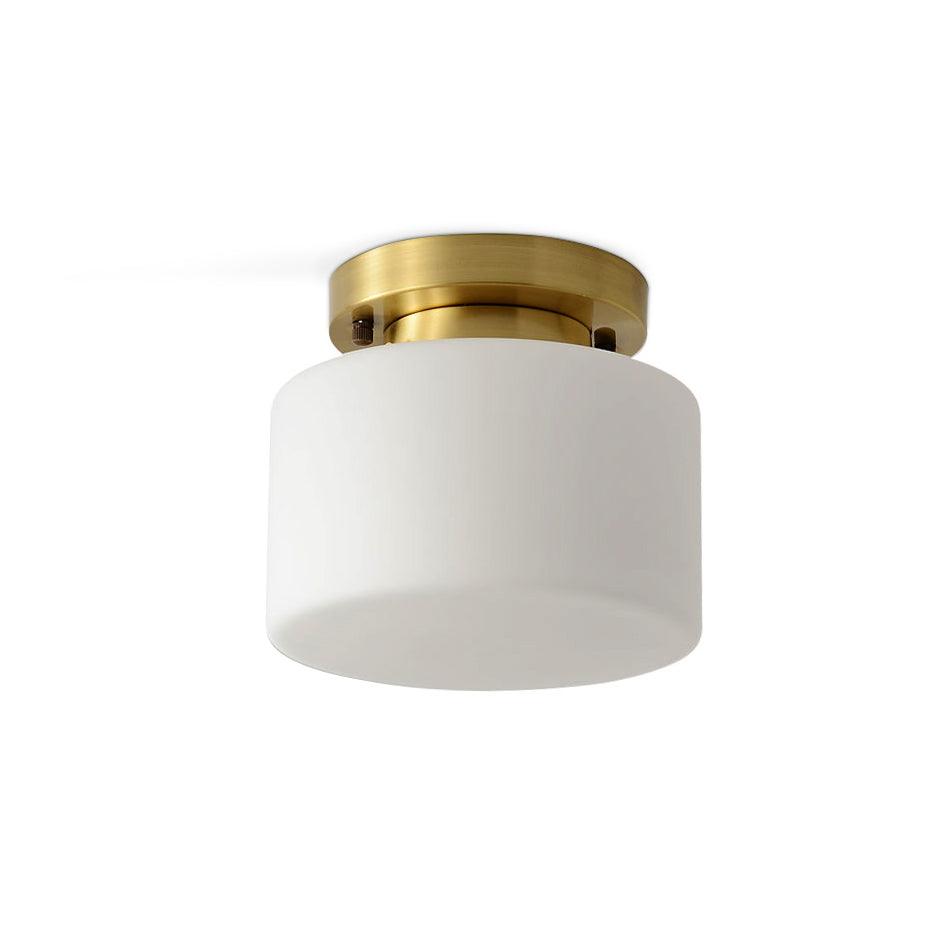 A Clérachic brass and white glass flush-mount light shown on a white backdrop, with the canopy fixings visible against the ceiling.