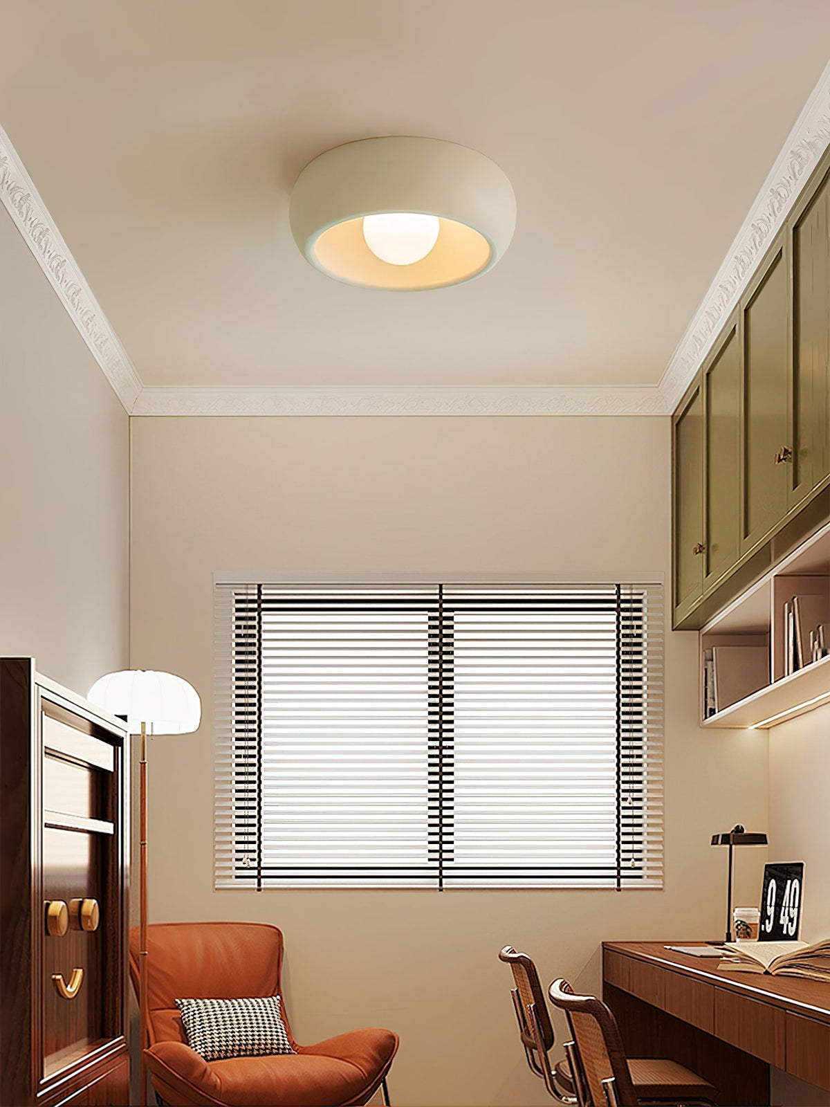 Beige Clérachic ceiling light centred in a study, with white cornicing, a rust-coloured armchair and a window with blinds below.