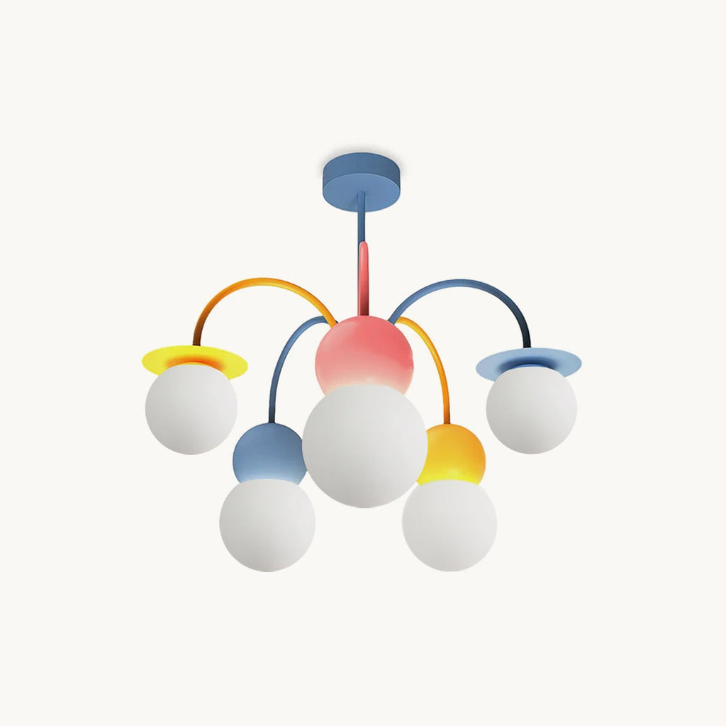 A Clérachic chandelier on a plain white backdrop, with a blue ceiling plate, pink centre and five white globes on yellow, orange and blue arms.