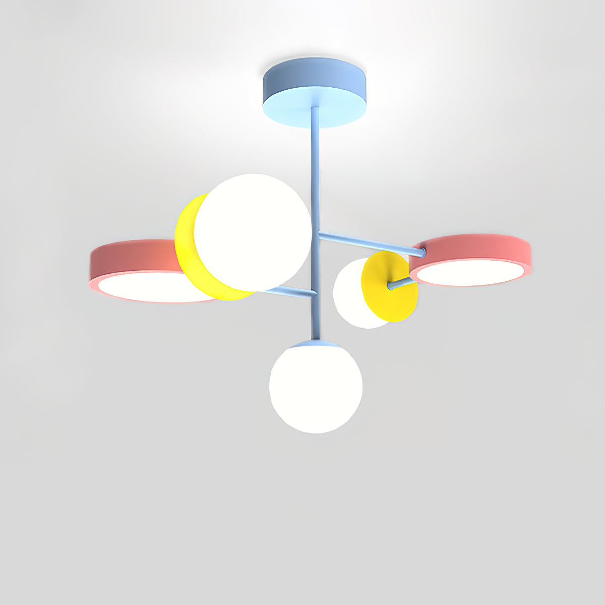 Close view from below of this Clérachic chandelier, showing its pale blue stem, pink and yellow discs and frosted white globes on a grey backdrop.