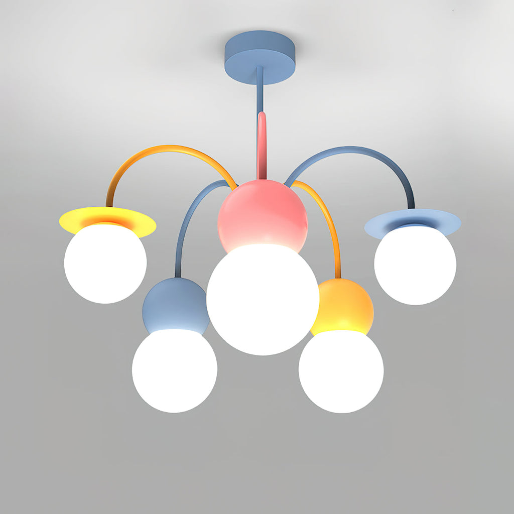 Front view of this Clérachic chandelier lit on a grey backdrop, with a pink centre, curved orange and blue arms and five glowing white globes.