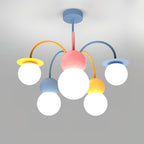 Front view of this Clérachic chandelier lit on a grey backdrop, with a pink centre, curved orange and blue arms and five glowing white globes.