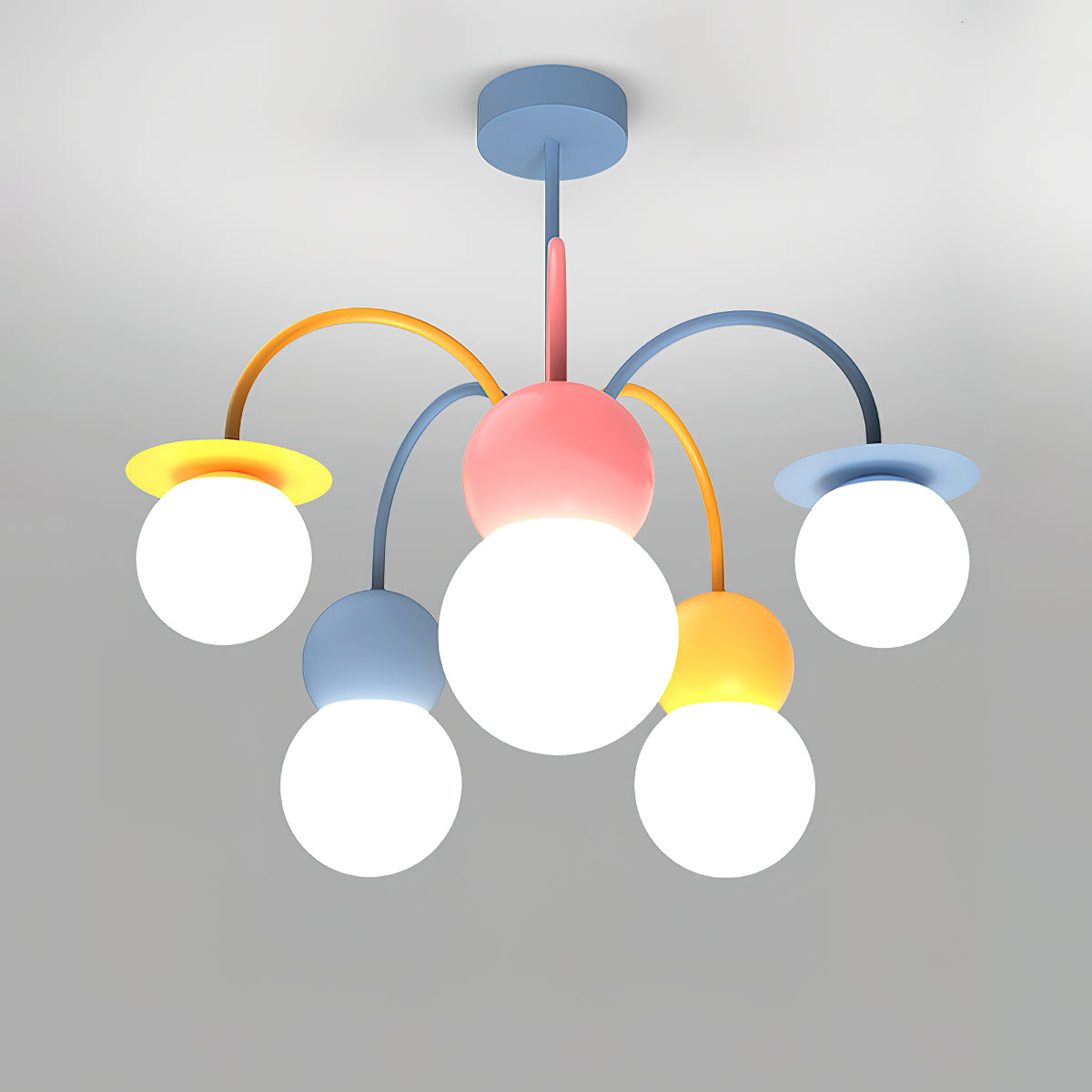 Front view of this Clérachic chandelier lit on a grey backdrop, with a pink centre, curved orange and blue arms and five glowing white globes.