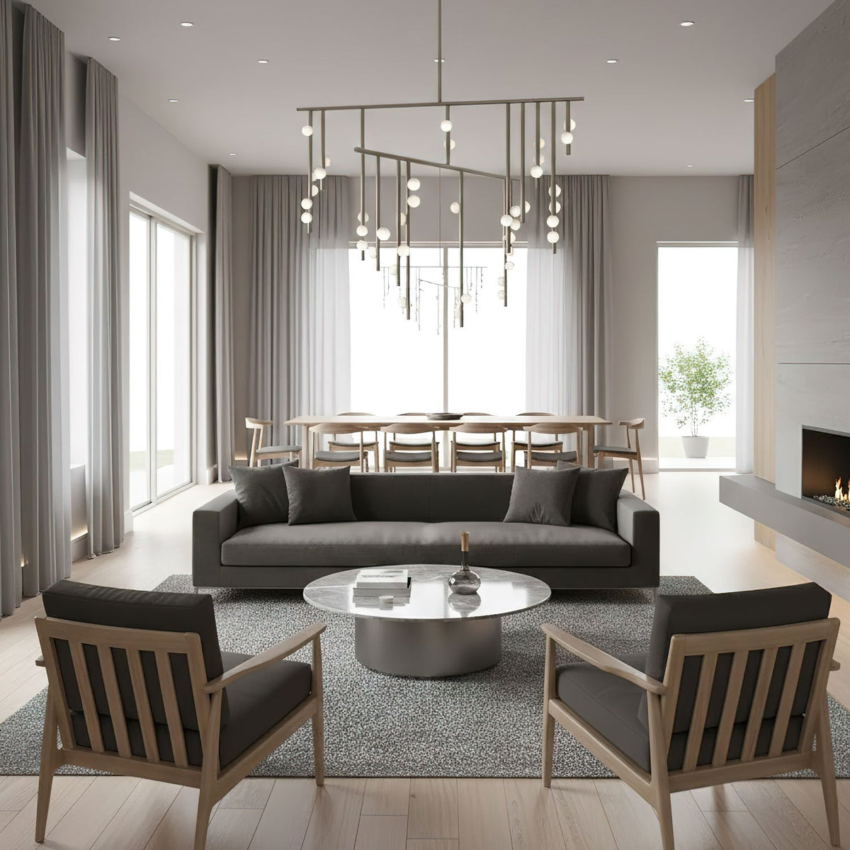 A Clérachic chandelier with brass bars and white orbs over a long dining table in a pale grey open-plan room, with a dark sofa in front.