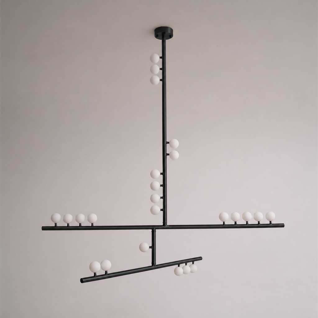This Clérachic pendant in black with a round ceiling plate and crossed bars of white orbs, against a soft grey wall.