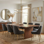 Over a live-edge wooden dining table, a Clérachic linear pendant with brass bars and white orbs sits in front of a round mirror.