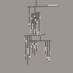 A black Clérachic chandelier with white glass orbs on a flat taupe backdrop, showing the layered bars.