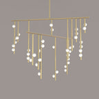 Close view of this Clérachic chandelier in brass, with two long bars and white orbs spaced along the hanging rods.