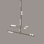 This Clérachic pendant in a pale nickel-toned finish on a taupe backdrop, with white orbs on the rod and bars.