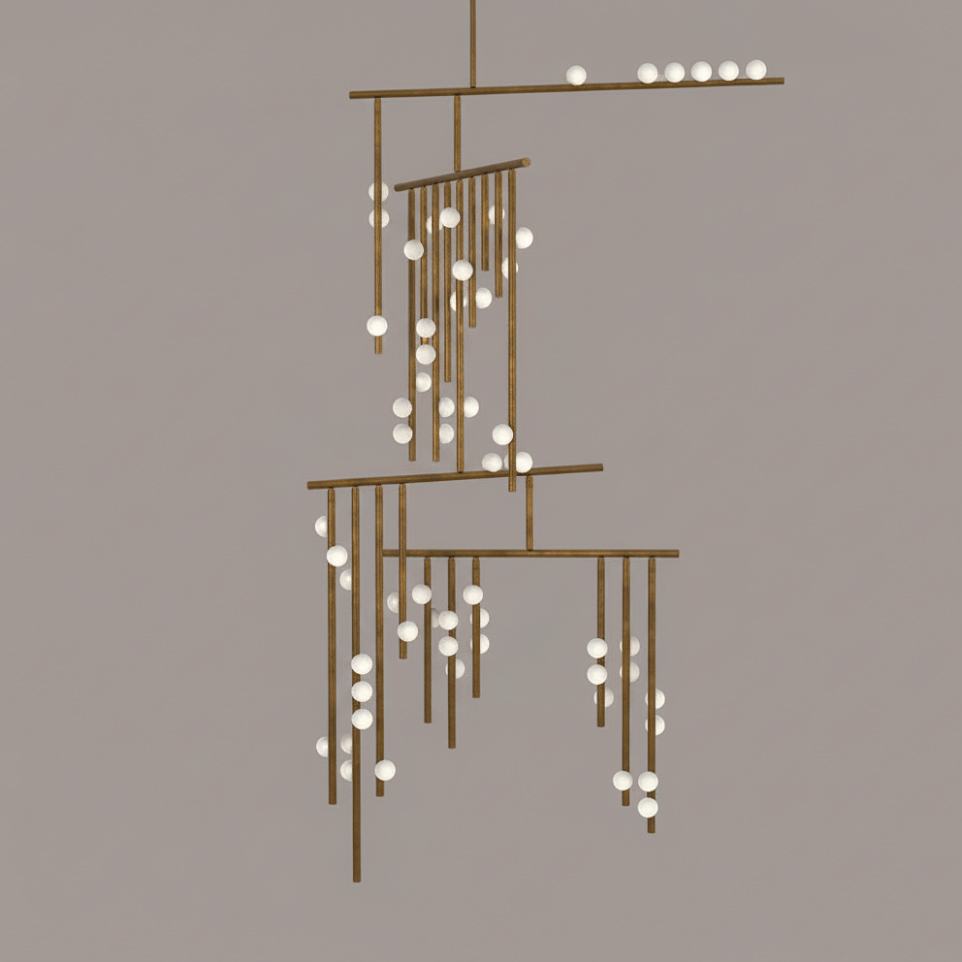 Antique bronze version of this Clérachic chandelier with white orbs, on a taupe backdrop.