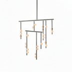 A Clérachic chandelier in a nickel-toned finish, on a white backdrop, with white orbs on each drop rod.