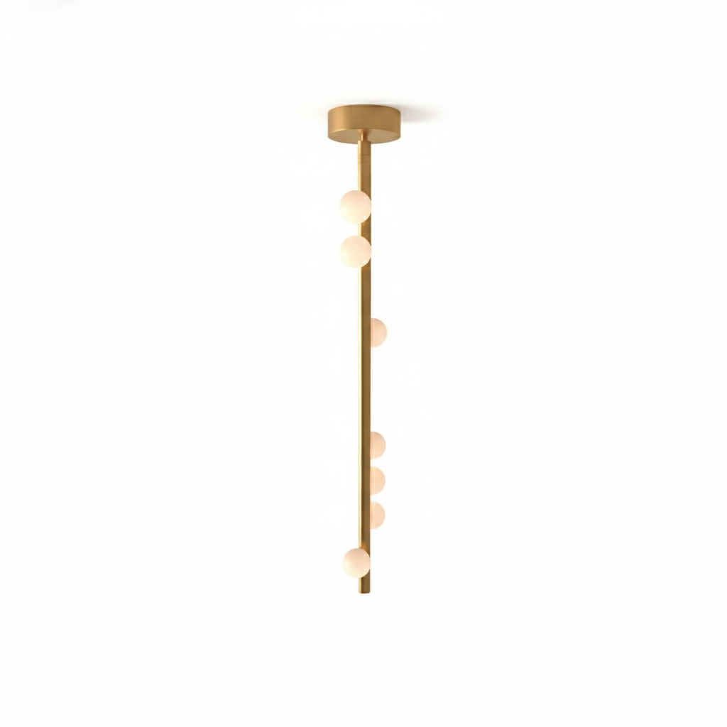 A Clérachic single-rod pendant in a softer brass tone with a round ceiling plate, on a white backdrop.