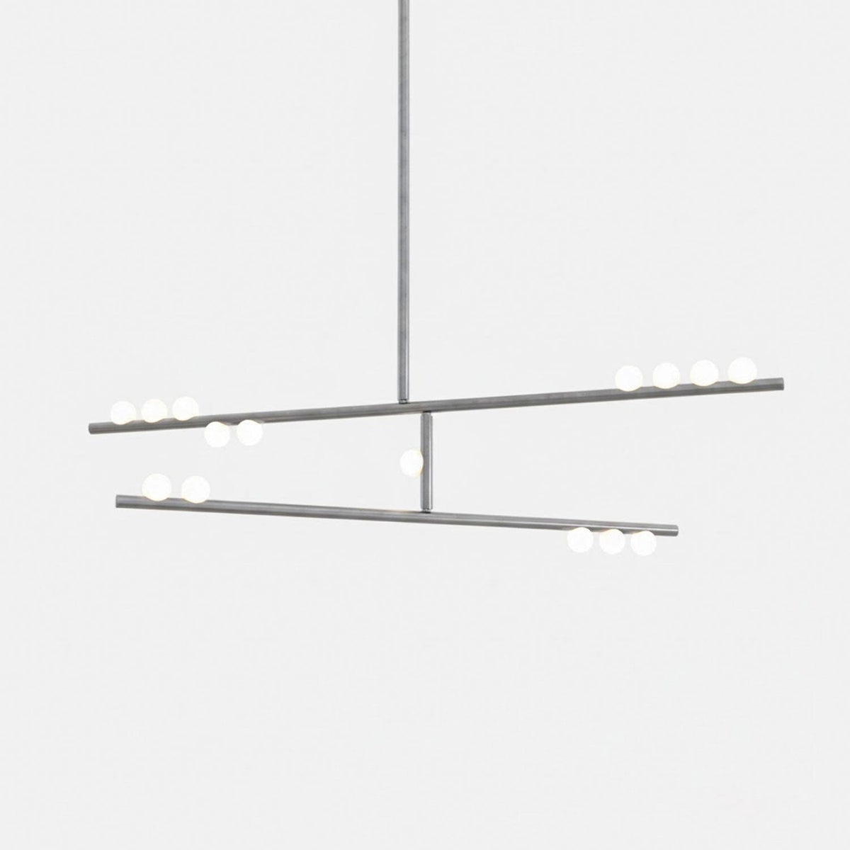 A Clérachic two-bar pendant in a nickel-toned finish with white orbs, on a pale backdrop.
