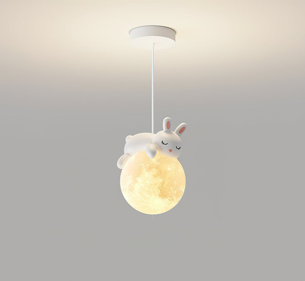 A white rabbit with pink-lined ears sleeps on the glowing globe of this Clérachic pendant, hung from a white ceiling plate.