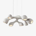 Clérachic pendant on a light backdrop, its white branching arms each ending in a rounded, bulb-lit opening.