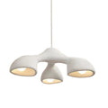 Three-arm Clérachic pendant on a white backdrop, a textured white form hanging from a single cable with three lit openings.
