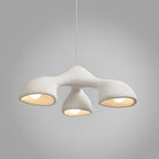 Clérachic pendant on a soft grey gradient, its three white arms glowing from within beneath a single hanging cable.
