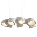 Side view of this Clérachic pendant on white, four white openings in a row, each holding a lit bulb, hung from three cables.