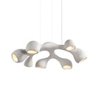 Clérachic pendant on white, branching white arms each ending in a bulb-lit opening, hung from three thin cables.