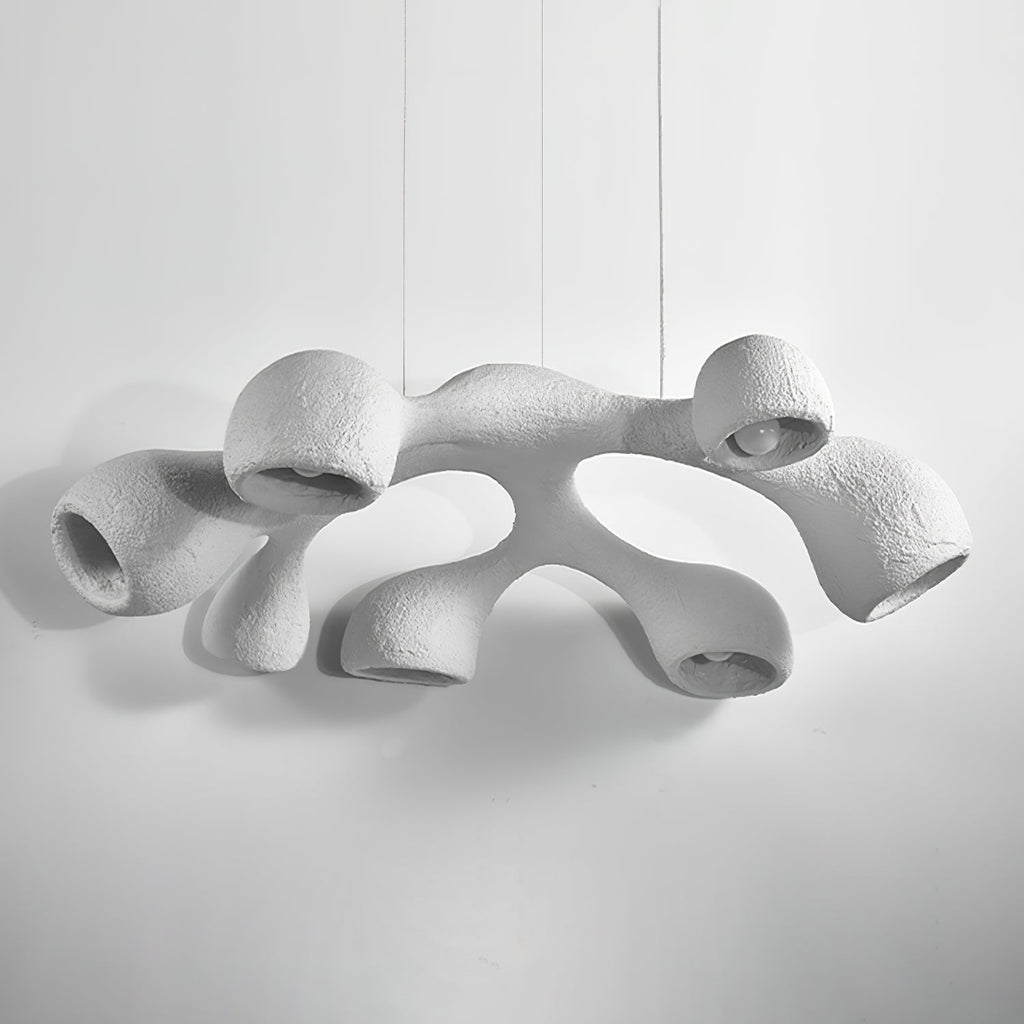 Clérachic pendant seen from slightly below on a light grey backdrop, its white arms switched off and openings facing down.