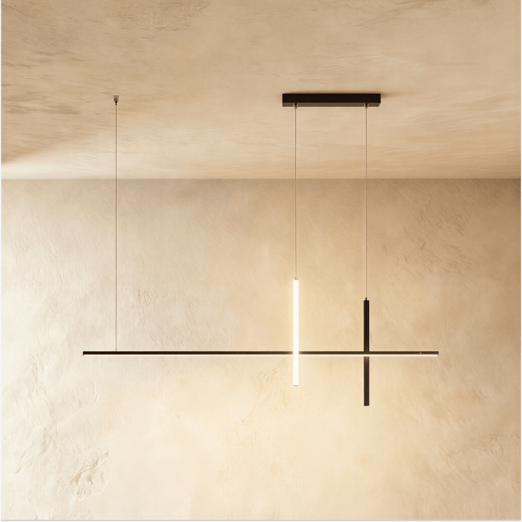 Clérachic pendant light in black, one vertical bar glowing warm white where it crosses the long horizontal arm.