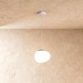 Clérachic pebble-shaped white pendant with a smooth frosted shade on two fine wires from a white round canopy