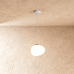 Clérachic pebble-shaped white pendant with a smooth frosted shade on two fine wires from a white round canopy