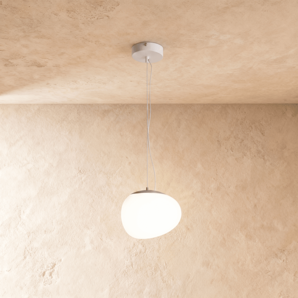 Clérachic glowing white pebble pendant with an uneven rounded shade and a grey metal cap on thin suspension wires