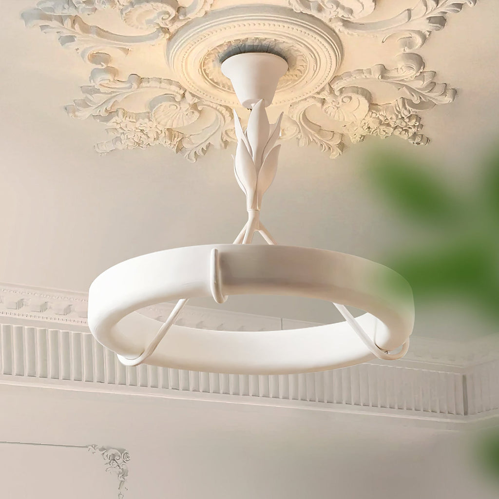 Under-view of this Clérachic ceiling light below an ornate plaster ceiling rose, its leaf-shaped stem joining a white plaster ring.