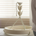 Clérachic ceiling light resting on a table before blinds, the plaster ring, three struts, leaf stem and a hanging chain all in view.