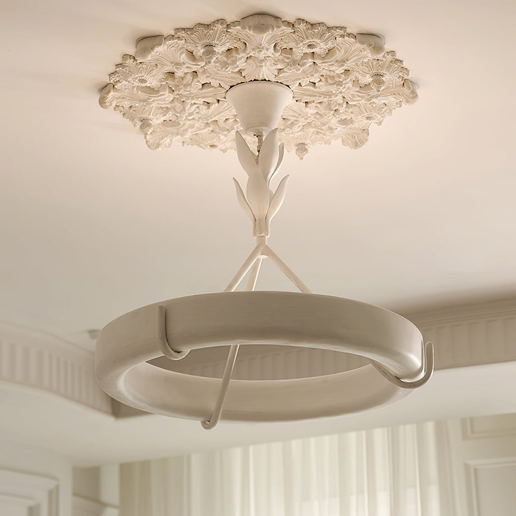 Clérachic ceiling light below a carved plaster rose, in a room with a coved ceiling and white curtains at the far side.