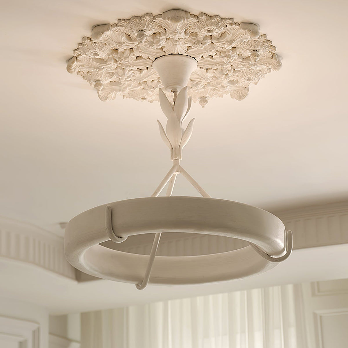 Clérachic ceiling light below a carved plaster rose, in a room with a coved ceiling and white curtains at the far side.