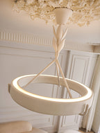 Close view of the lit plaster ring and leaf-wrapped stem of this Clérachic ceiling light, with a ceiling rose above.