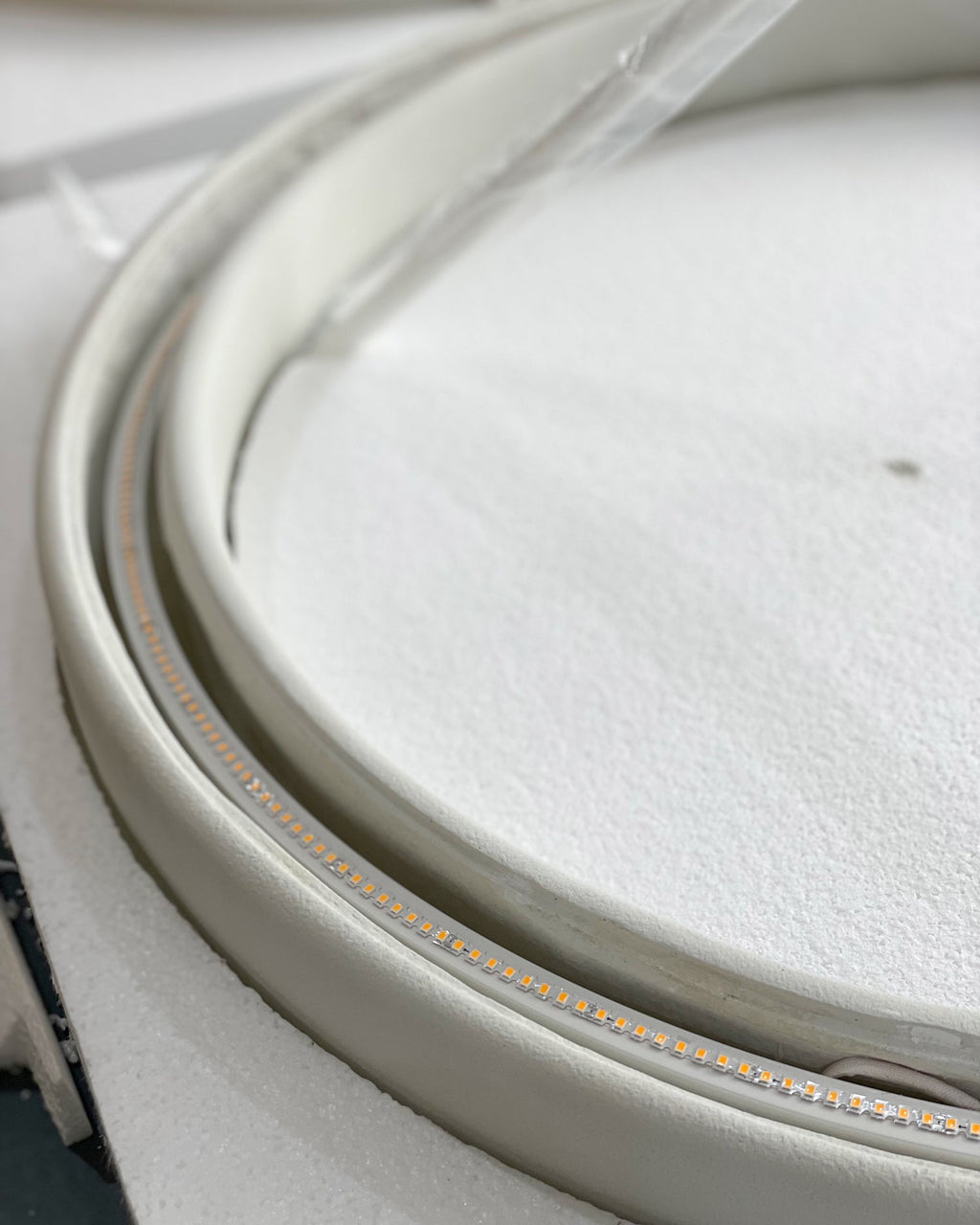 Close view of the LED strip fitted inside the plaster ring of this Clérachic ceiling light.