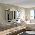 Two Clérachic wall lamps in black mounted above framed mirrors in a travertine double-vanity bathroom.