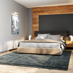 Clérachic wall lamp in white mounted beside framed art in a warm-toned bedroom with a wood accent wall.